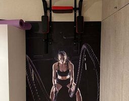Fotobehang Battle ropes session. Attractive young fit and toned sportswoman working out in fitness  training gym